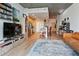 Modern living room featuring an open kitchen, a large tv and a comfortable seating area with hardwood floors at 860 Peachtree Ne St # 904, Atlanta, GA 30308