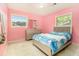 This bedroom features a large bed, dresser, and two windows at 1239 Sharonton Dr, Stone Mountain, GA 30083