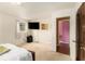 This bedroom features a TV, a bed with a decorative headboard, and carpeted floors at 1239 Sharonton Dr, Stone Mountain, GA 30083