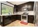 Galley kitchen features dark wood cabinets and stainless steel appliances at 1239 Sharonton Dr, Stone Mountain, GA 30083