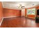 Spacious living room featuring hardwood floors, a ceiling fan, and a large window at 1239 Sharonton Dr, Stone Mountain, GA 30083