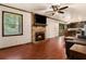 Open-concept living room with fireplace, dark wood floors, and view of kitchen and dining area at 1239 Sharonton Dr, Stone Mountain, GA 30083