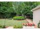Lush backyard featuring a manicured lawn, landscaped garden beds, and a play area, creating a private retreat at 3151 Amesbury Way, Duluth, GA 30096