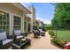 Spacious backyard patio with a seating area, a barbecue grill, and a well-maintained lawn surrounded by greenery at 3151 Amesbury Way, Duluth, GA 30096