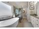 Luxurious bathroom featuring a soaking tub, glass-enclosed shower, and elegant fixtures at 3151 Amesbury Way, Duluth, GA 30096