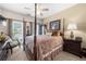 Cozy bedroom with a canopy bed, neutral colors, and window with blinds at 3151 Amesbury Way, Duluth, GA 30096