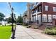 Beautiful view of the neighborhood with red lawn chairs, greenery, and a stone walkway at 3151 Amesbury Way, Duluth, GA 30096
