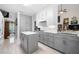 Modern kitchen featuring gray cabinetry, white countertops, and stainless steel appliances, offering sleek functionality at 3151 Amesbury Way, Duluth, GA 30096