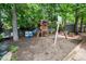 Backyard playground with a wooden play set, swings, a slide, and seating, ideal for ' outdoor activities at 3151 Amesbury Way, Duluth, GA 30096