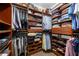 Well-organized walk-in closet with custom shelving, hanging racks, and ample storage space at 3151 Amesbury Way, Duluth, GA 30096
