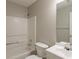 Bathroom with combined tub and shower, toilet and sink with mirror at 4045 Meadow Glen Way, Fairburn, GA 30213
