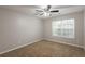 Neutral bedroom with carpet, ceiling fan and a bright window at 4045 Meadow Glen Way, Fairburn, GA 30213