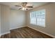 Neutral bedroom with wood floors, ceiling fan and bright window at 4045 Meadow Glen Way, Fairburn, GA 30213