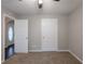 Neutral bedroom with carpet, two doors, one to hallway with arch and the other for closet at 4045 Meadow Glen Way, Fairburn, GA 30213