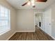 Neutral bedroom with wood floors, ceiling fan and a bright window at 4045 Meadow Glen Way, Fairburn, GA 30213