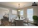 Staged dining room with a round table, pendant light, and a door to the exterior at 4045 Meadow Glen Way, Fairburn, GA 30213