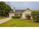 Charming yellow home with blue shutters, green lawn and mature trees at 4045 Meadow Glen Way, Fairburn, GA 30213