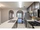 Kitchen features stainless appliances, dark cabinets and a serving bar open to living room at 4045 Meadow Glen Way, Fairburn, GA 30213