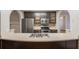 Modern kitchen features a curved island and bar with stainless appliances at 4045 Meadow Glen Way, Fairburn, GA 30213