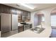 Modern kitchen features stainless appliances, dark cabinets and a tiled backsplash at 4045 Meadow Glen Way, Fairburn, GA 30213