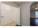 Bright laundry room with tile floors and storage shelving, located just off the main hallway at 4045 Meadow Glen Way, Fairburn, GA 30213