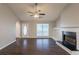 Spacious living room with dark floors, ceiling fan, fireplace, and lots of natural light at 4045 Meadow Glen Way, Fairburn, GA 30213