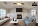 Staged living room featuring a fireplace, vaulted ceilings, and an open layout to the kitchen at 4045 Meadow Glen Way, Fairburn, GA 30213