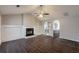 Bright living room featuring a fireplace, vaulted ceilings, and an open layout to the kitchen at 4045 Meadow Glen Way, Fairburn, GA 30213