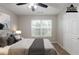 Staged main bedroom with carpet, ceiling fan and a bright window and door at 4045 Meadow Glen Way, Fairburn, GA 30213