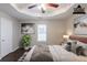 Staged main bedroom with hardwood floors, a tray ceiling, and neutral colors at 4045 Meadow Glen Way, Fairburn, GA 30213