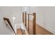 Hallway featuring hardwood floors, a modern railing, and access to multiple rooms at 651 Soul Aly # 135, Alpharetta, GA 30009