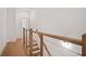 Hallway with hardwood floors and modern railing, showcasing sleek design and natural light at 651 Soul Aly # 135, Alpharetta, GA 30009