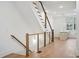 Staircase with wood and metal railing, and a view to the kitchen at 651 Soul Aly # 135, Alpharetta, GA 30009