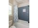 Bathroom showcasing blue tiled shower with built-in niche and shower curtain at 1142 Wiley Bridge Rd, Woodstock, GA 30188