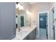 Bathroom features a double vanity with gray cabinetry and a view into a tiled shower at 1142 Wiley Bridge Rd, Woodstock, GA 30188