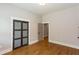 Bedroom with hardwood floors, paneled closet doors, and neutral paint at 1142 Wiley Bridge Rd, Woodstock, GA 30188