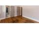 Bedroom featuring hardwood floors and a view into an ensuite bathroom at 1142 Wiley Bridge Rd, Woodstock, GA 30188