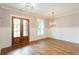 Bright dining room featuring hardwood floors, wainscoting, and a stylish chandelier at 1142 Wiley Bridge Rd, Woodstock, GA 30188