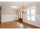Elegant dining room with hardwood floors, wainscoting, modern lighting, and large window at 1142 Wiley Bridge Rd, Woodstock, GA 30188