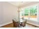 Cozy dining area with a glass table and natural light from a large window at 1142 Wiley Bridge Rd, Woodstock, GA 30188
