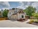 Side view of a charming two-story home with a two-car garage and inviting walkway at 1142 Wiley Bridge Rd, Woodstock, GA 30188