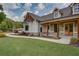 A charming two-story home showcasing a lush green lawn and a welcoming front porch at 1142 Wiley Bridge Rd, Woodstock, GA 30188