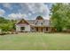 Charming two-story home featuring a landscaped yard and inviting front porch with wood columns at 1142 Wiley Bridge Rd, Woodstock, GA 30188