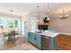 Open-concept kitchen with an island, stainless steel appliances, and a seamless transition to the dining area at 1142 Wiley Bridge Rd, Woodstock, GA 30188