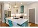 Kitchen featuring an island with barstool seating, quartz countertops, and stainless steel appliances at 1142 Wiley Bridge Rd, Woodstock, GA 30188