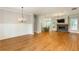 Spacious living room boasting hardwood floors, wainscoting, a modern fireplace, and ample natural light at 1142 Wiley Bridge Rd, Woodstock, GA 30188