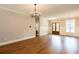 Bright living room featuring hardwood floors, a modern chandelier, and entry at 1142 Wiley Bridge Rd, Woodstock, GA 30188