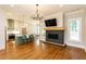 Spacious living area with an open floor plan, fireplace, and hardwood floors leading to the kitchen at 1142 Wiley Bridge Rd, Woodstock, GA 30188
