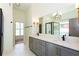 Bright main bathroom with double vanity, modern fixtures, and glass enclosed shower at 1142 Wiley Bridge Rd, Woodstock, GA 30188