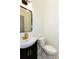 Charming powder room with ship lap accent wall, modern fixtures, and decorative tile flooring at 1142 Wiley Bridge Rd, Woodstock, GA 30188